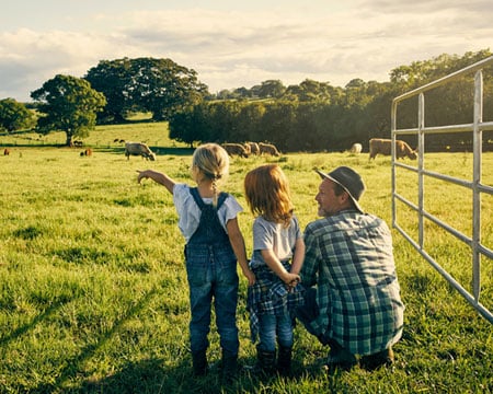 male-farmer-and-his-two-kids-on-their-farm