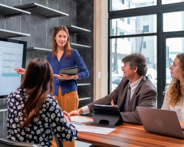 woman presenting to coworkers in a meeting