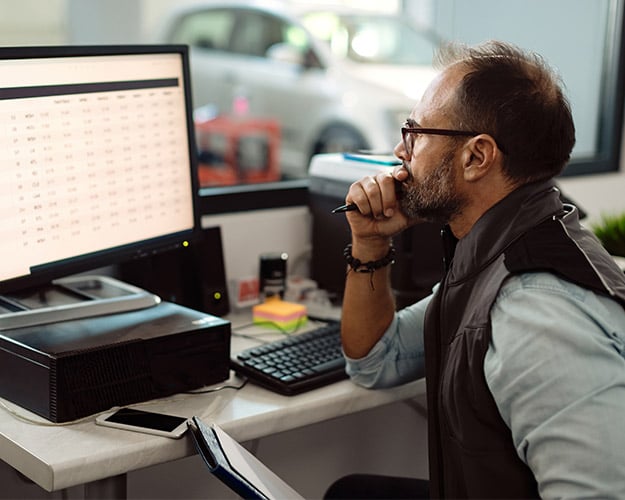 man looking at data on the computer