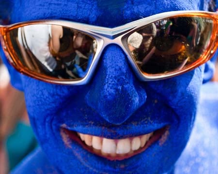 A blue body painted party fan