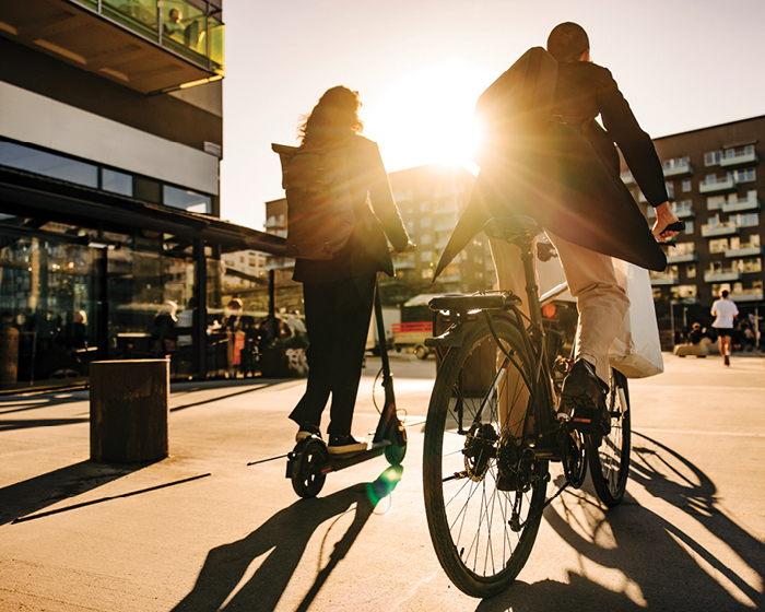 man riding bike and woman riding scooter