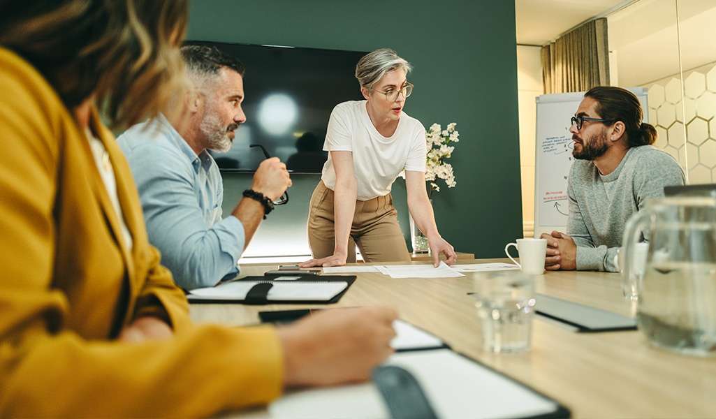 woman leading a meeting at a conference table