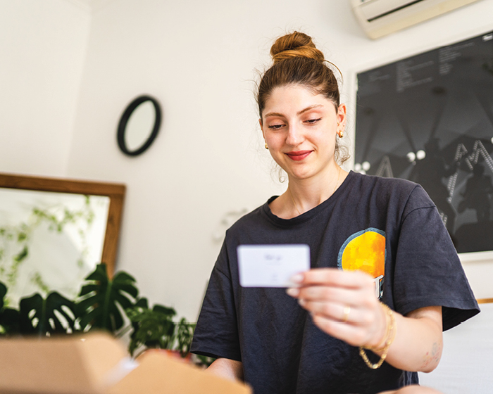 young woman looking at a card