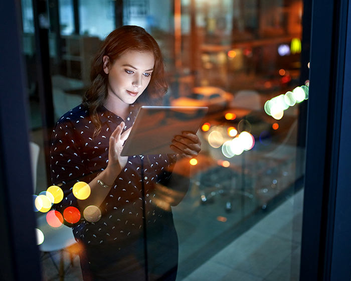 woman looking at tablet