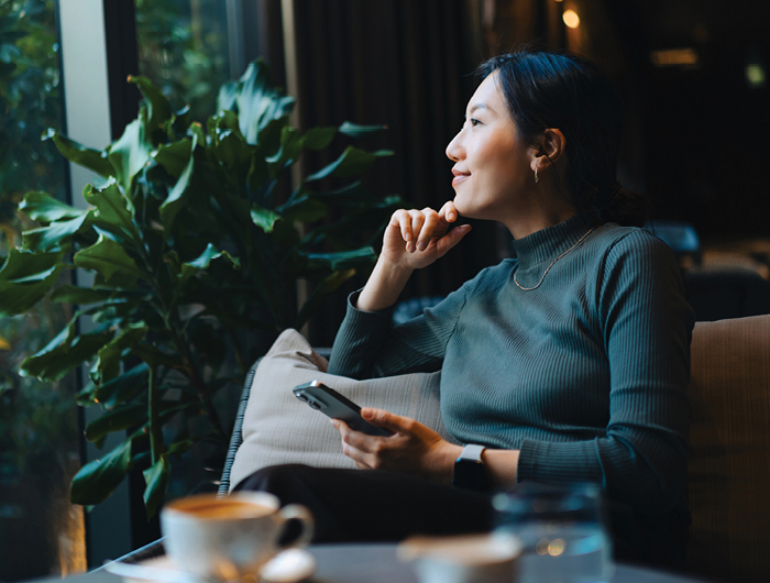 woman smiling while looking out window