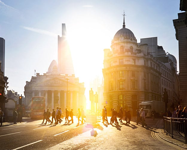 people in london walking to work with sunrise