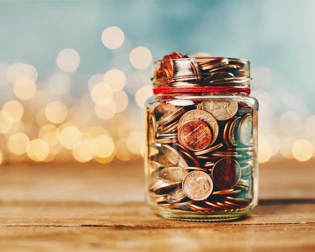 Donation money jar filled with coins