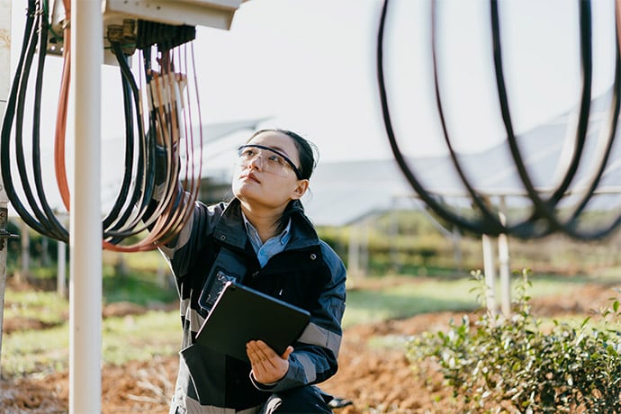 woman working on solar panels