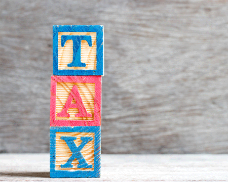 Color-letter-block-in-word-tax-on-wood-background