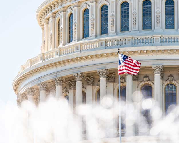 US Congress dome closeup with background of water fountain splashing