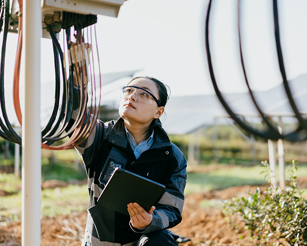 woman working on solar panels