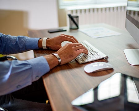 man working at desk computer