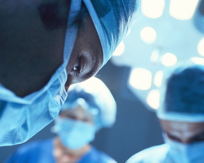 closeup of healthcare workers face in operating room