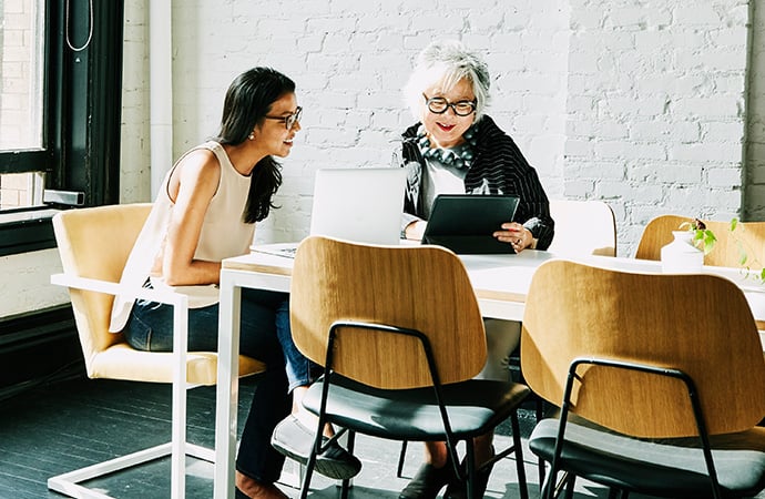 two women sitting in a meeting