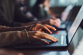 person typing on a laptop