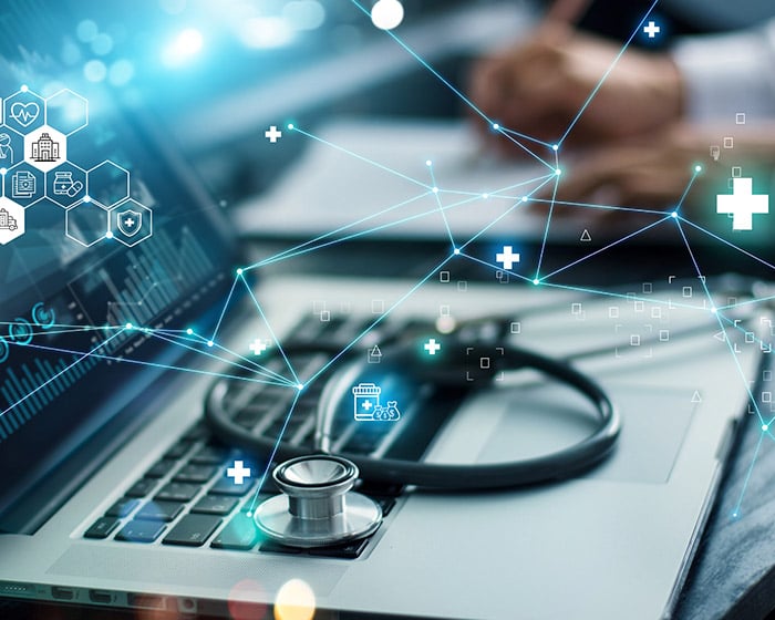 stethoscope on laptop with healthcare and technology graphics