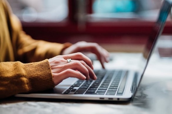 hands typing on laptop