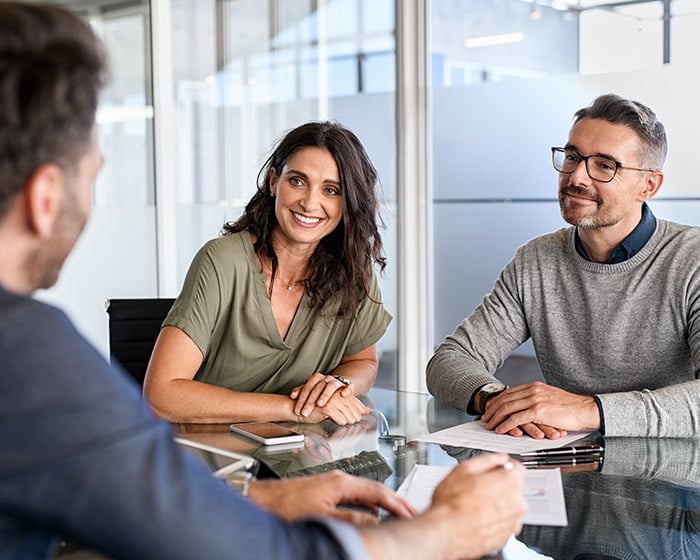 two men and one woman in team meeting