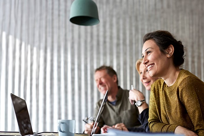 woman in meeting smiling