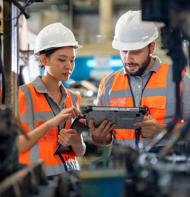 manufacturing employees looking at tablet