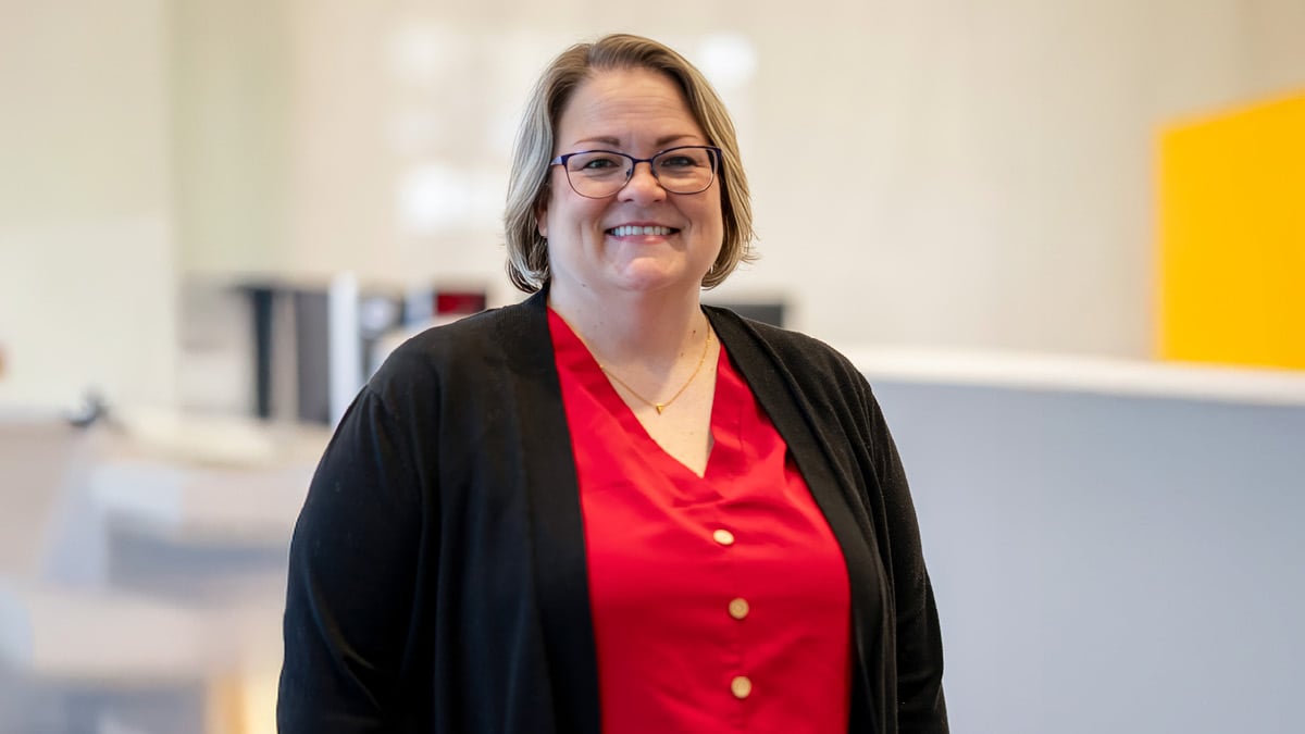 Rehabilitation hospital employee Farrah Haney recognized as OEAA South Atlantic winner, pictured wearing a red blouse and black cardigan within a hospital environment representing clinical leadership and staff achievement.