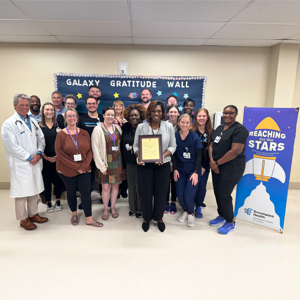Encompass Health Rehabilitation Hospital of Columbia staff receive a proclamation for National Rehabilitation Awareness Week