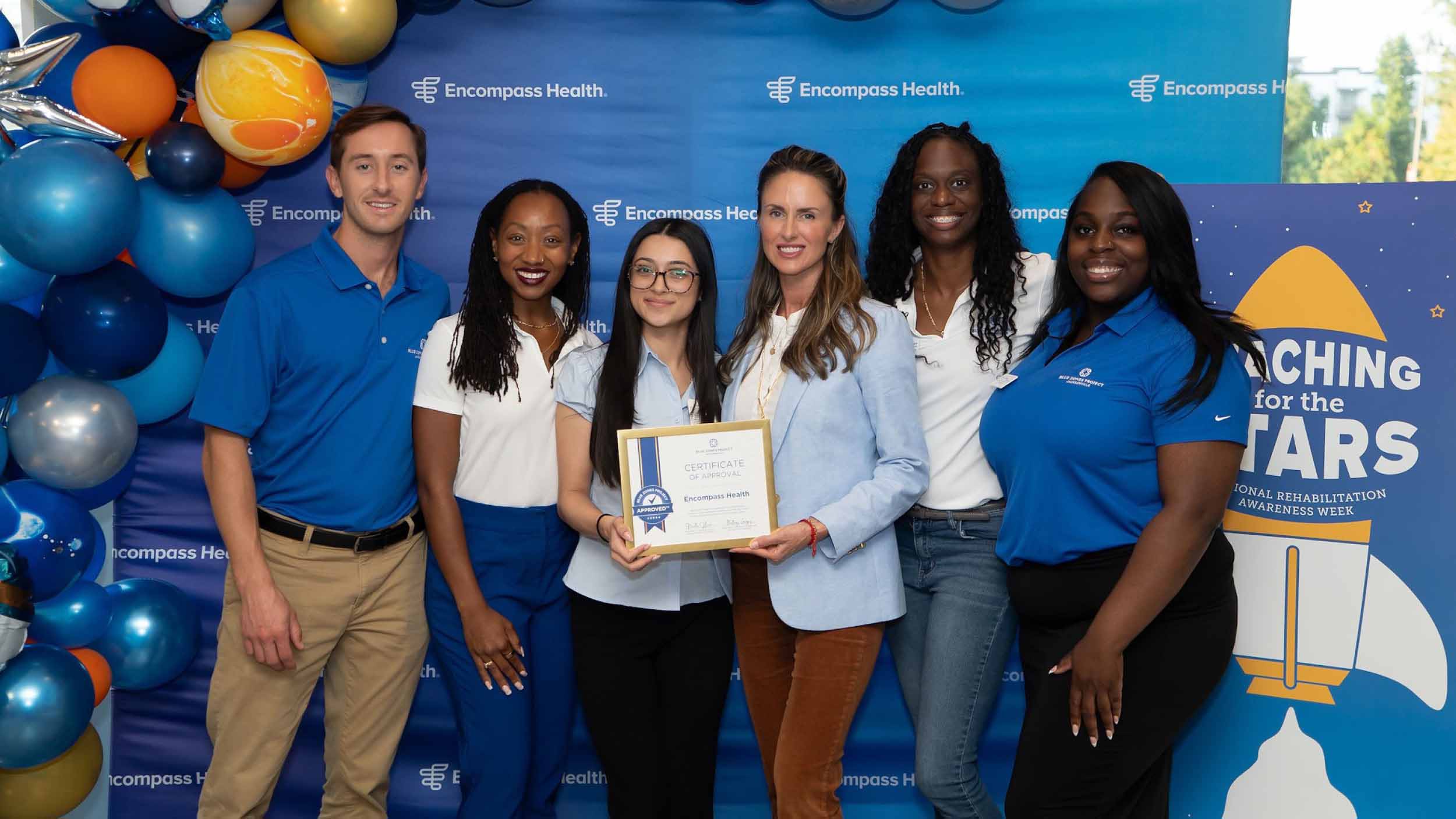 Employee group photo holding up a certificate