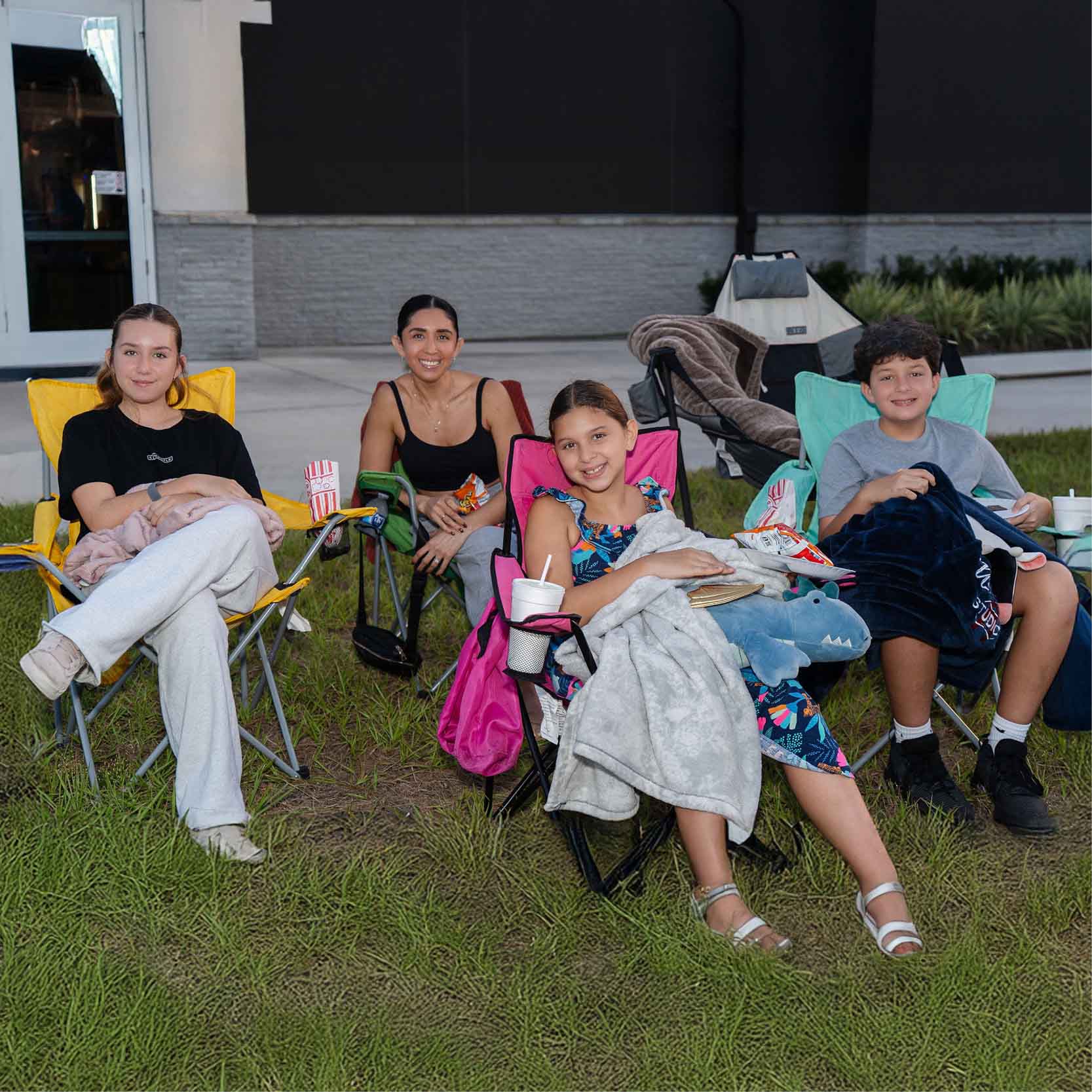 Family sitting in lawn chairs outside of our hospital