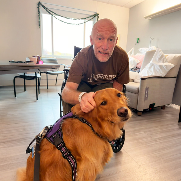 Ascension St. John Rehabilitation Hospital of Owasso therapy dog Molly visiting a patient.