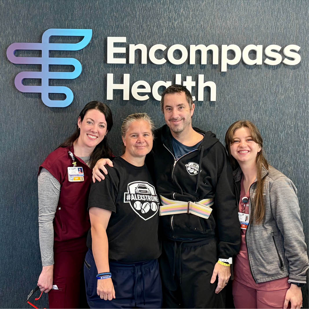 Plymouth Police Chief Alex Hutchins, his wife and two Encompass Health employees smiling in front of an 