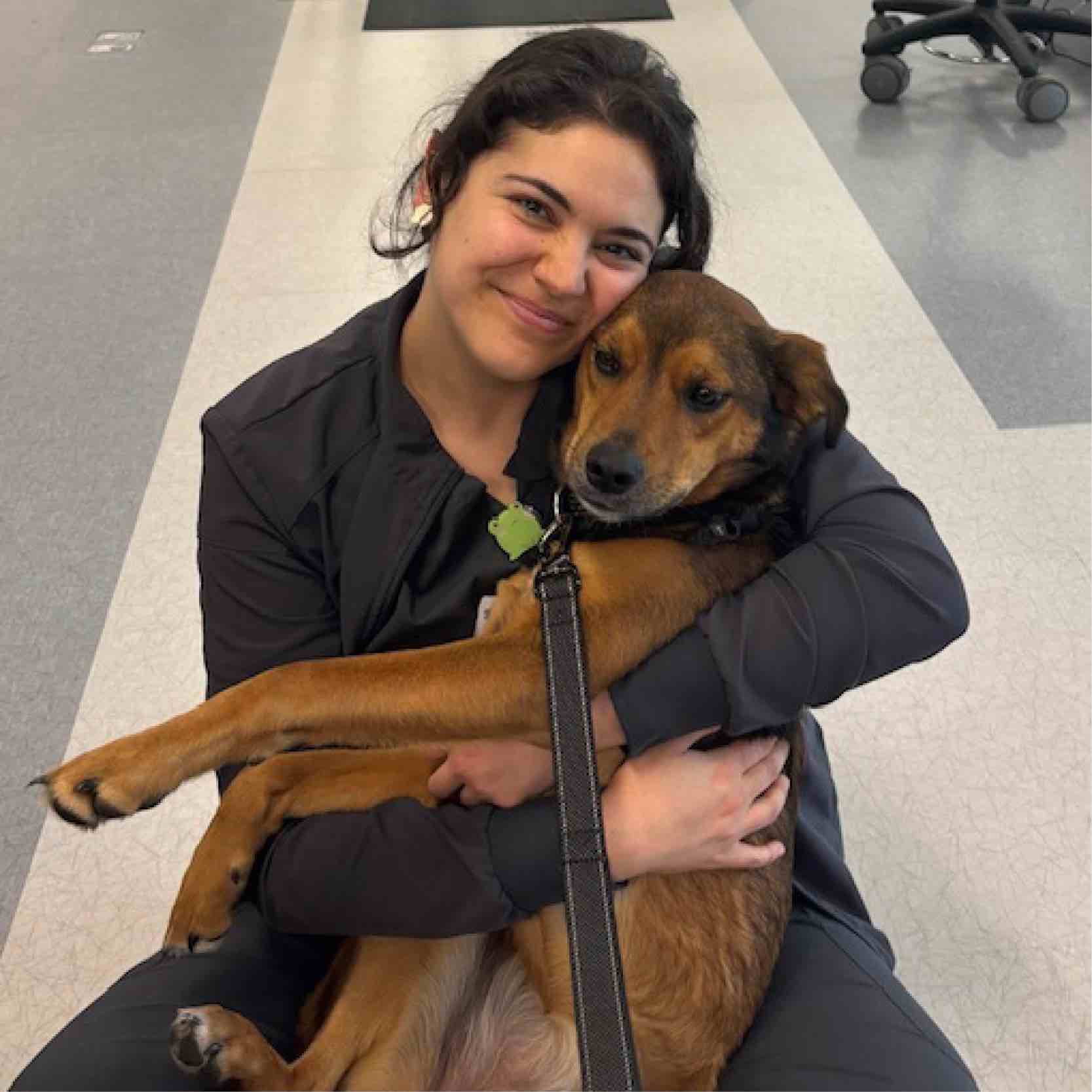 Rehabilitation team member in Greenville embraces a therapy dog during pet therapy activities, reflecting calm, supportive environments for care and healing.