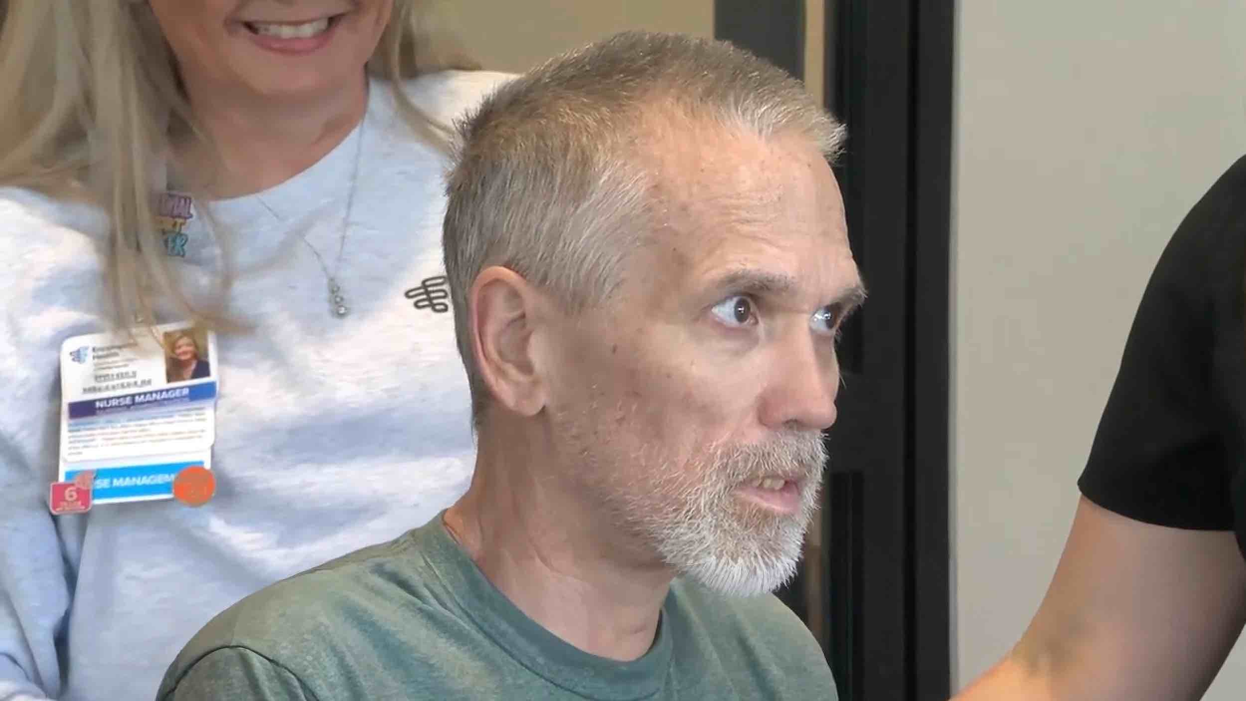 Police Chaplain participates in recovery at a rehabilitation hospital in Shelby County, seated during care activities with clinical staff support in a therapy environment.