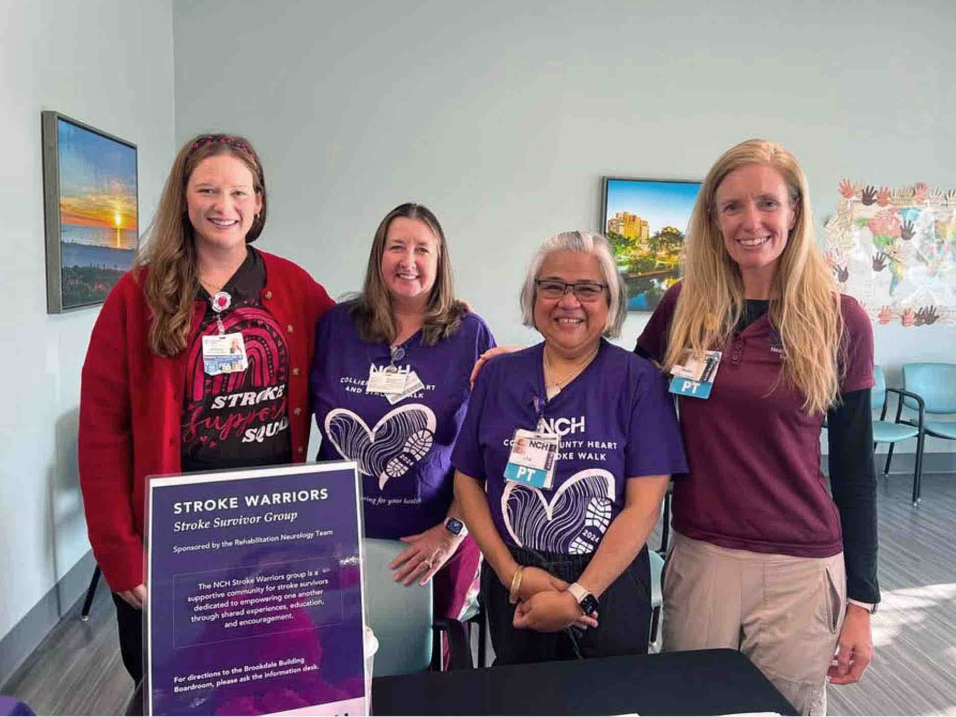 Group of healthcare professionals standing beside a Stroke Warriors sign, representing a stroke survivor support program focused on rehabilitation, recovery, and community-based stroke care education.