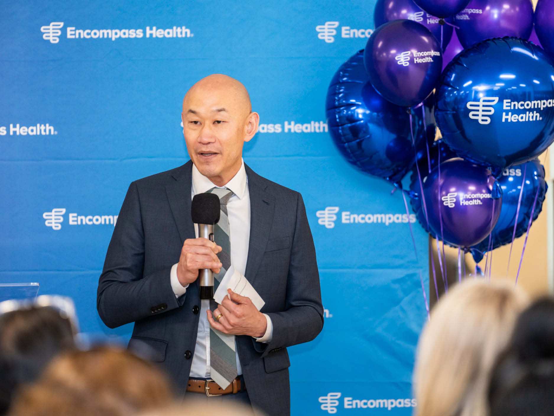 Speaker addresses attendees during the Katy expansion celebration at Encompass Health, highlighting growth in rehabilitation services and patient care.