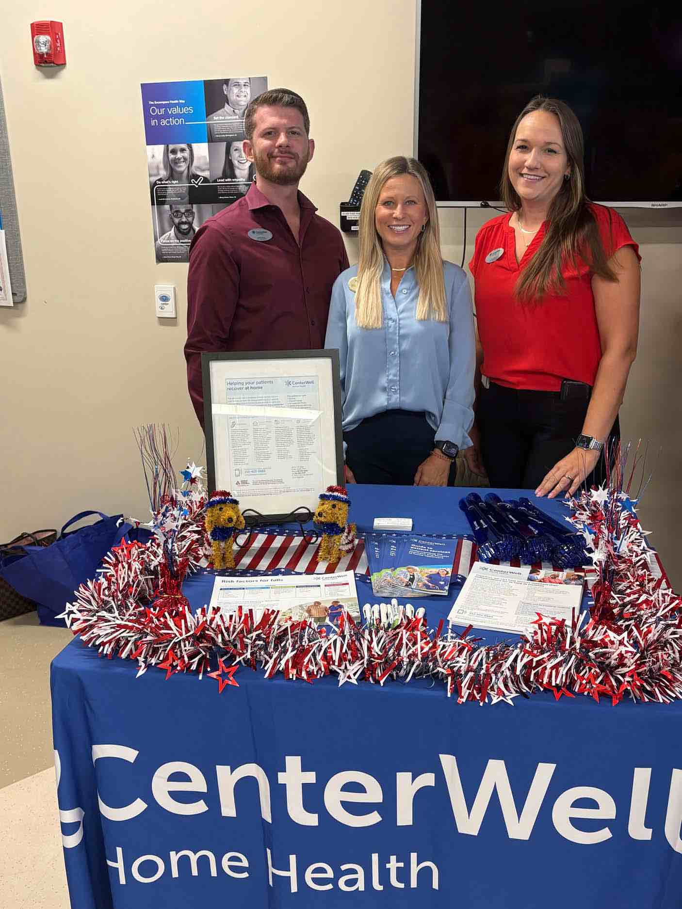 Community partners host an informational booth during a veterans appreciation event, sharing healthcare resources and support services for veterans and caregivers.