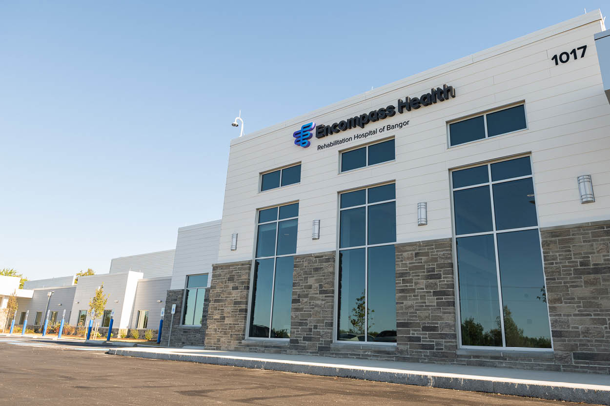 Exterior of Encompass Health Rehabilitation Hospital of Bangor during the grand opening, featuring the hospital entrance and signage.