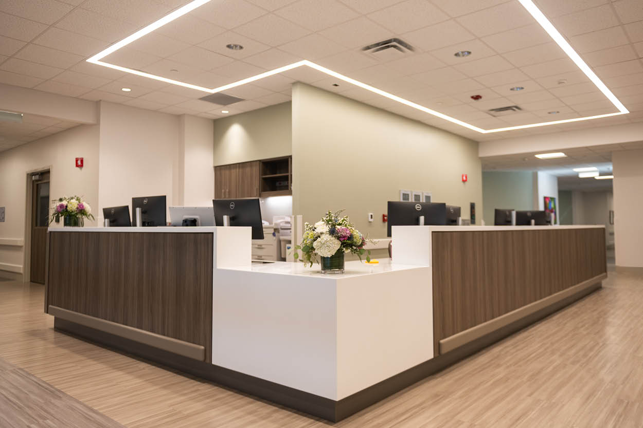 Reception area at Encompass Health Rehabilitation Hospital of Bangor highlighted during the grand opening, featuring a modern front desk.