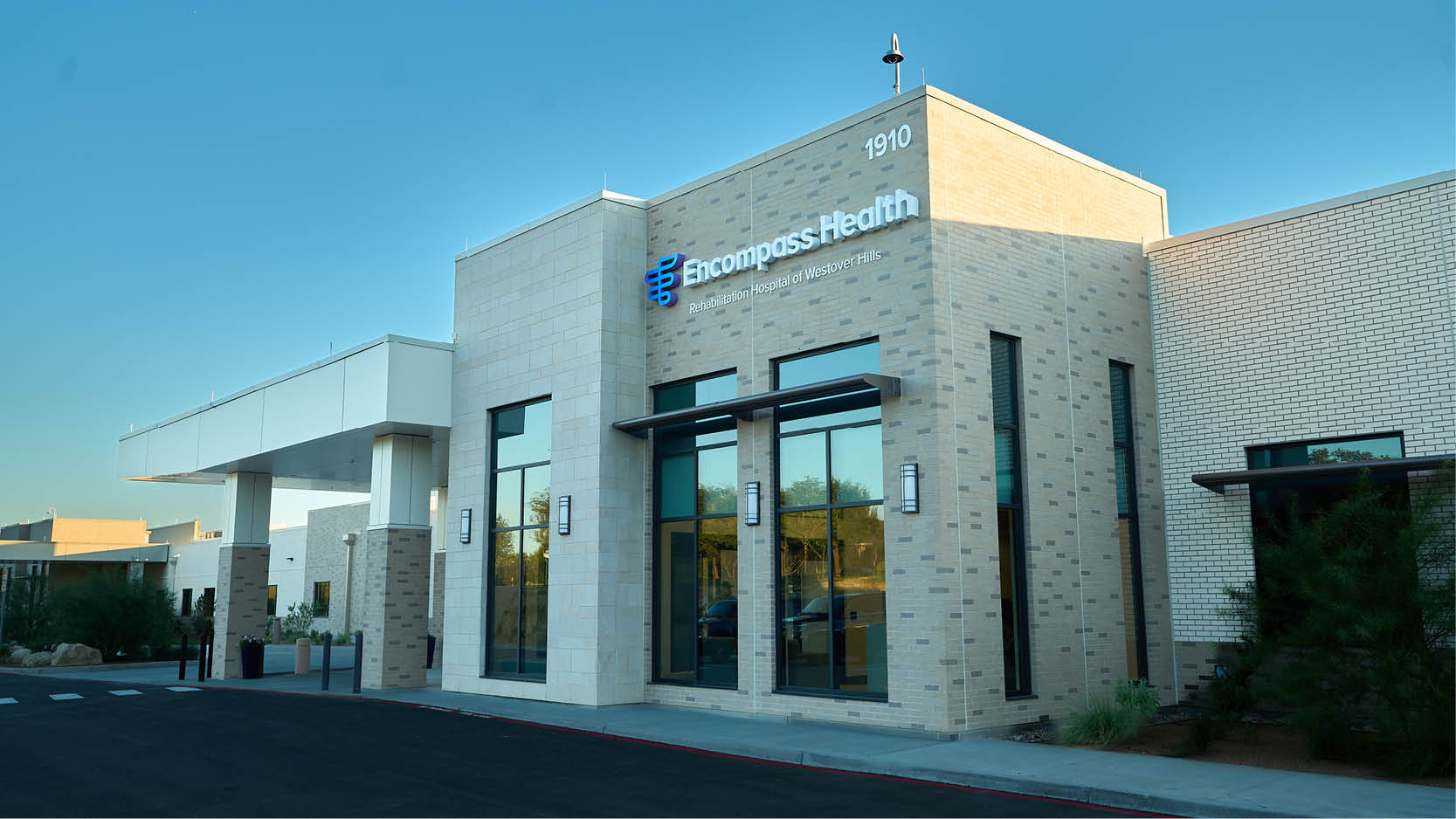 Exterior of Encompass Health Rehabilitation Hospital of Westover Hills during the grand opening, featuring hospital signage and entrance.