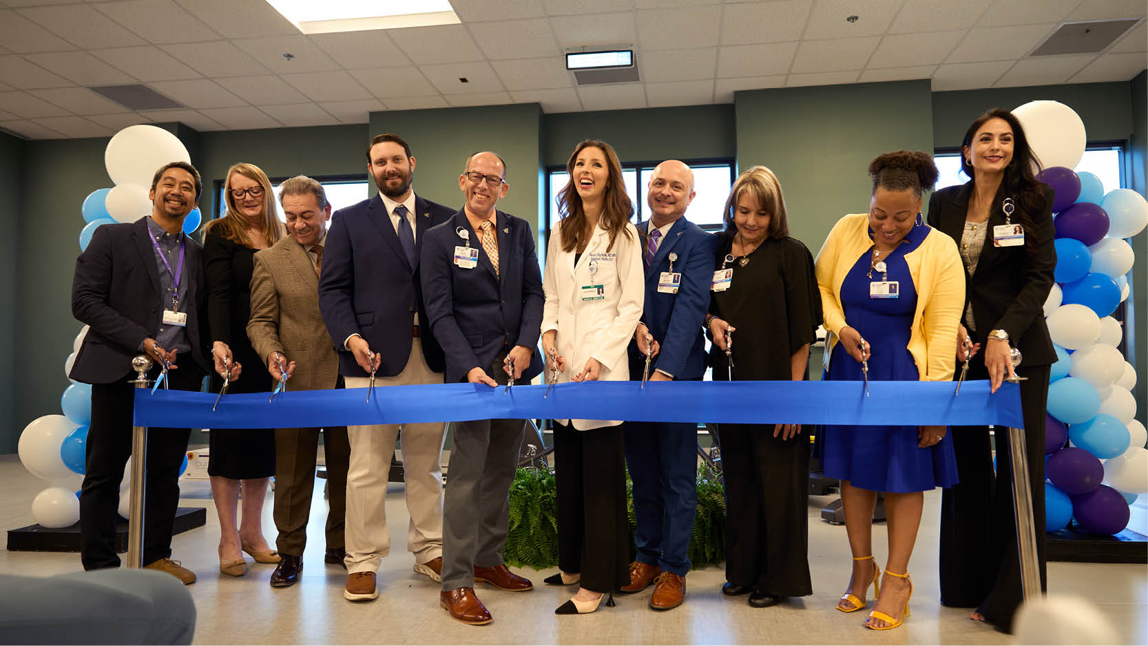 Community members and healthcare leaders participate in a ribbon-cutting ceremony celebrating the Encompass Health Westover Hills grand opening.