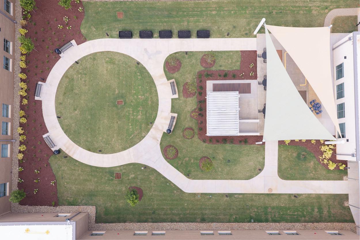 Aerial view of Encompass Health Greenville's expanded rehabilitation hospital campus featuring landscaped outdoor spaces.