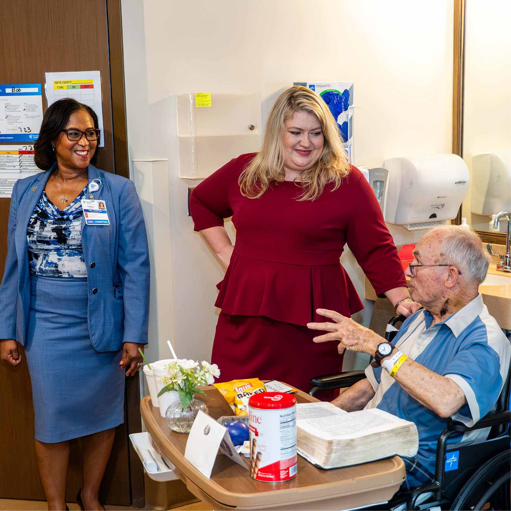 Congresswoman Kat Cammack visits with a patient during a rehabilitation hospital tour, learning about recovery experiences and inpatient rehabilitation care.