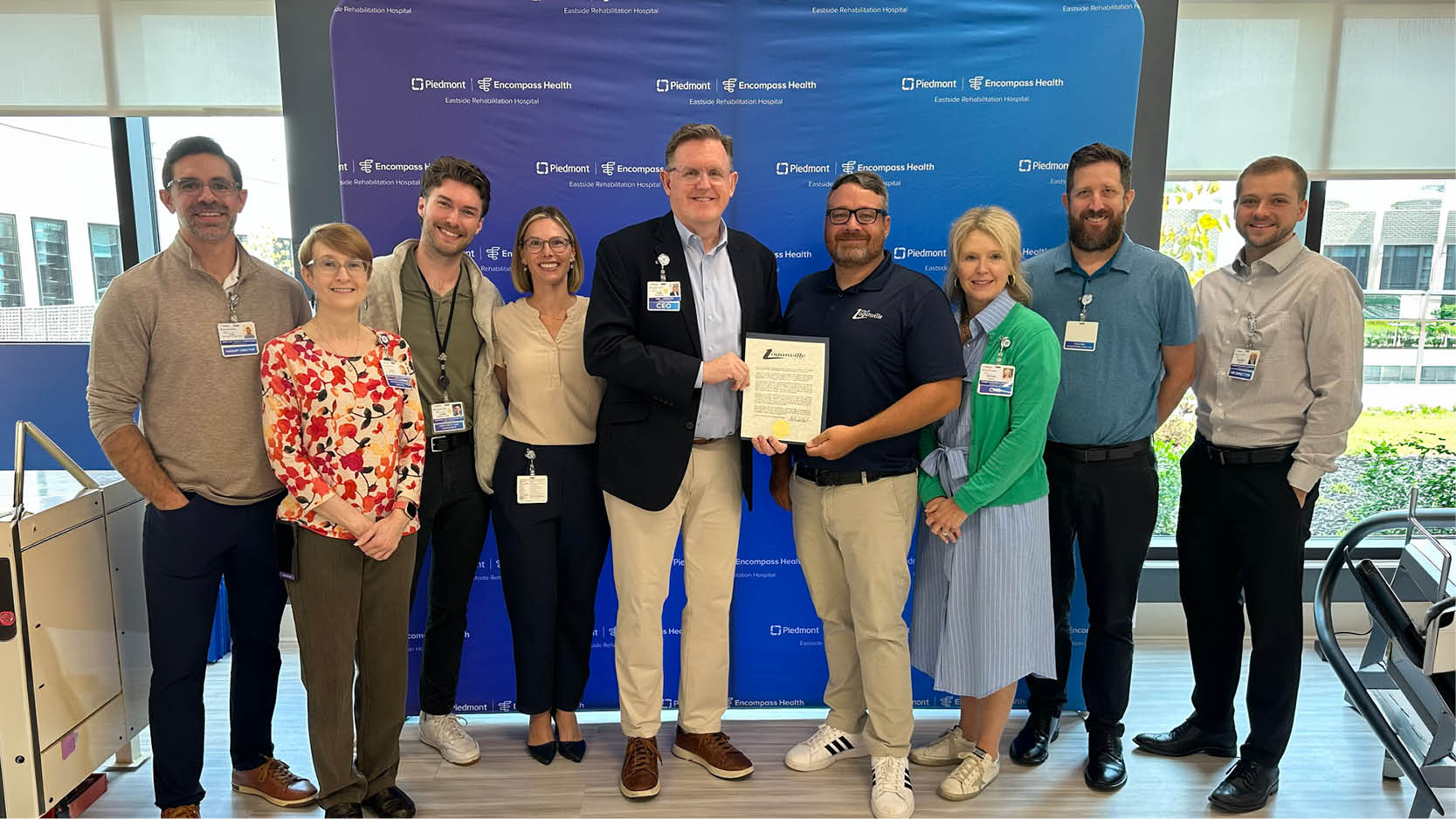 Officials and staff at Piedmont Healthcare Encompass Health Eastside Rehabilitation Hospital welcome Mayor Brandon during a community recognition event celebrating rehabilitation care and partnership.