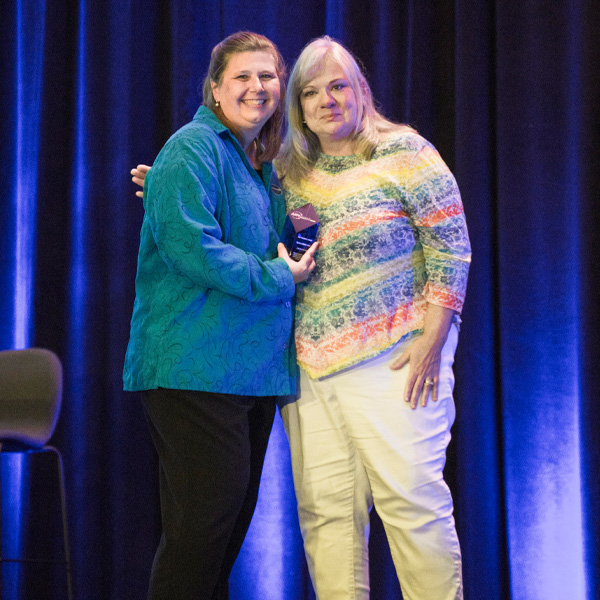 Barbara Winters-Todd posing on stage during the ARN President's Award ceremony