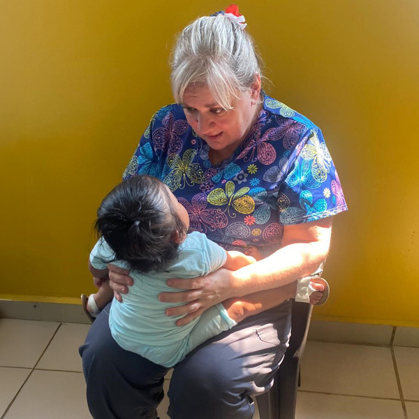 Barbara Winters-Todd holding a baby