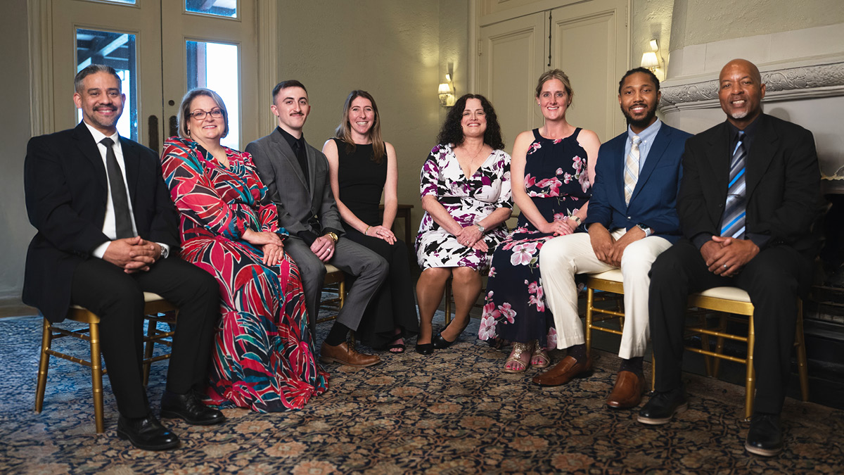 OEAA award winners seated for a gala portrait, left to right: Jerry Garzaro, Farrah Haney, Jacob Smith, Sara Whitney, Evangelina Badell, Jennifer Illuminati, Trevor Johnson, Randall Fannin.