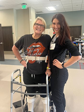 Anne Thomas with a physical therapist