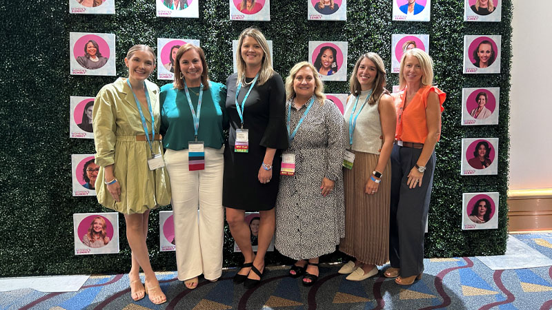 Jennifer Baswell posing with Encompass Health staff