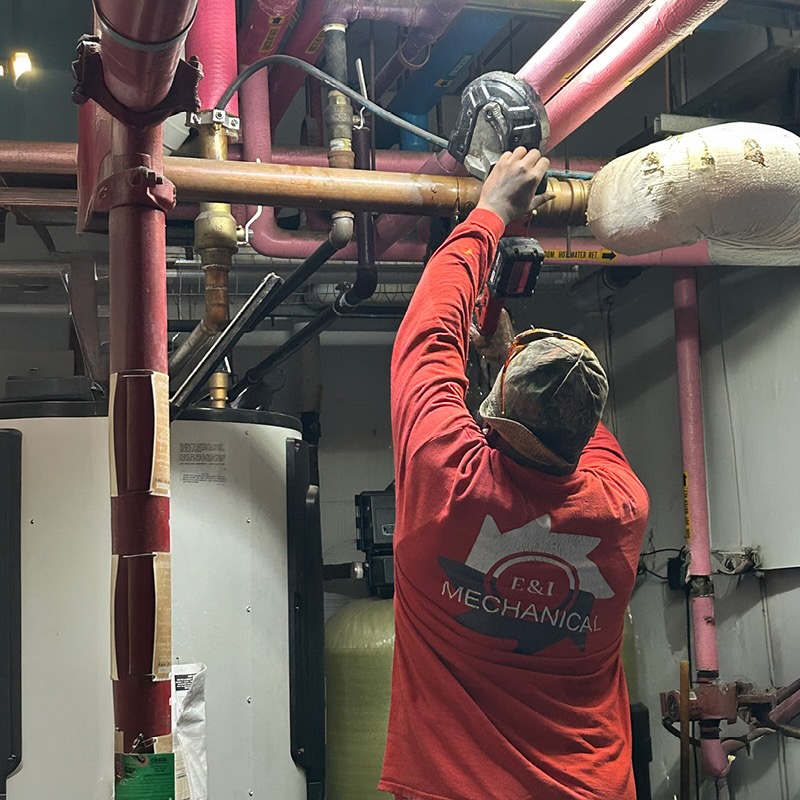 A technician in a red shirt labeled 