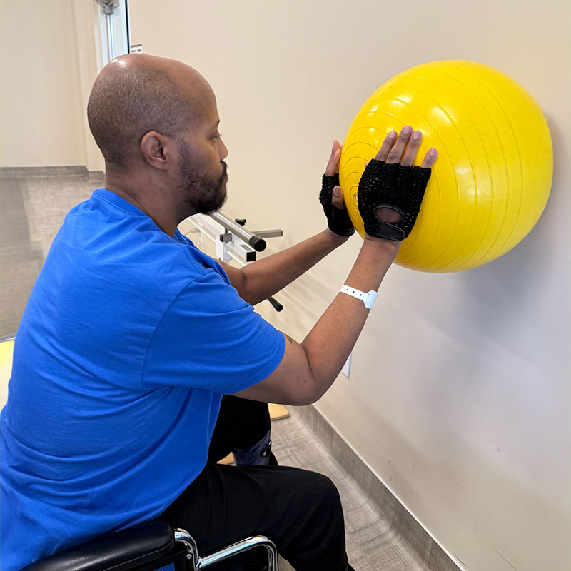 Joe Pearson performing physical therapy with a stability ball