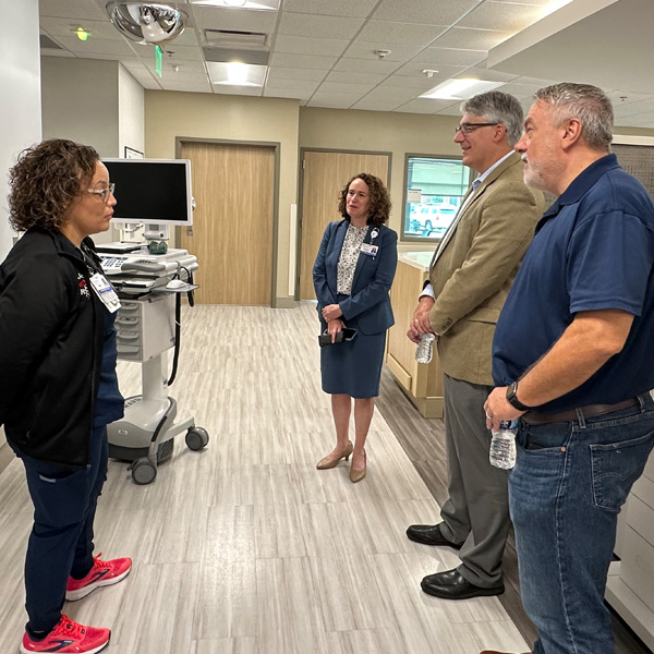 Illinois State legislators speaking with a staff member at The Quad Cities Rehabilitation Institute
